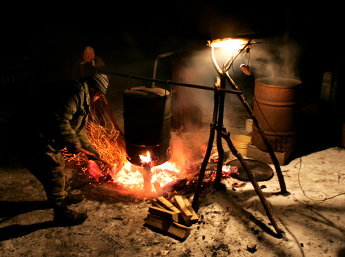 A villager produces moonshine vodka. Photo by Julia Darashkevich